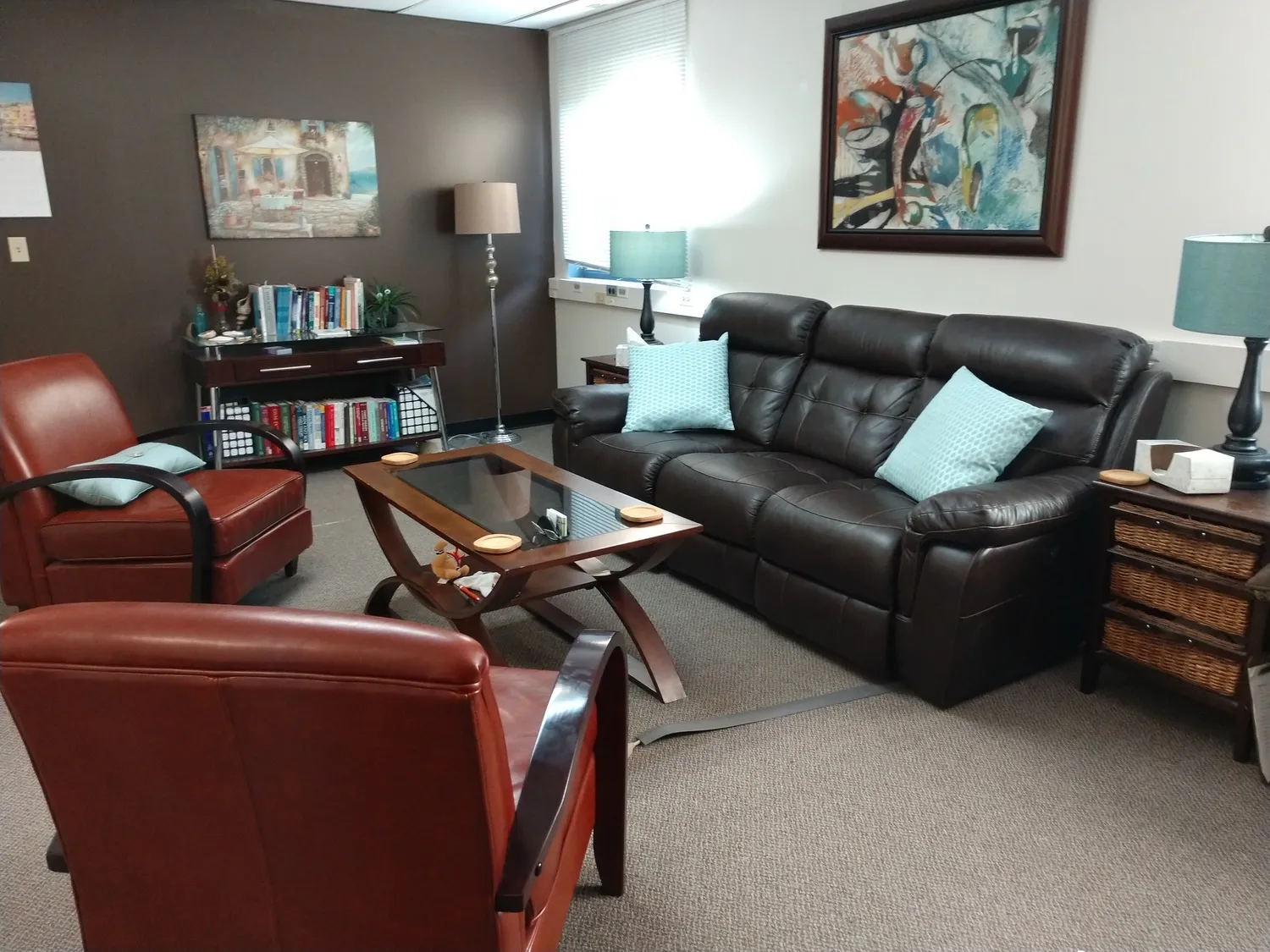 Scott Swagger's therapy office in Lincoln, with leather chairs, a sofa and soft lamps