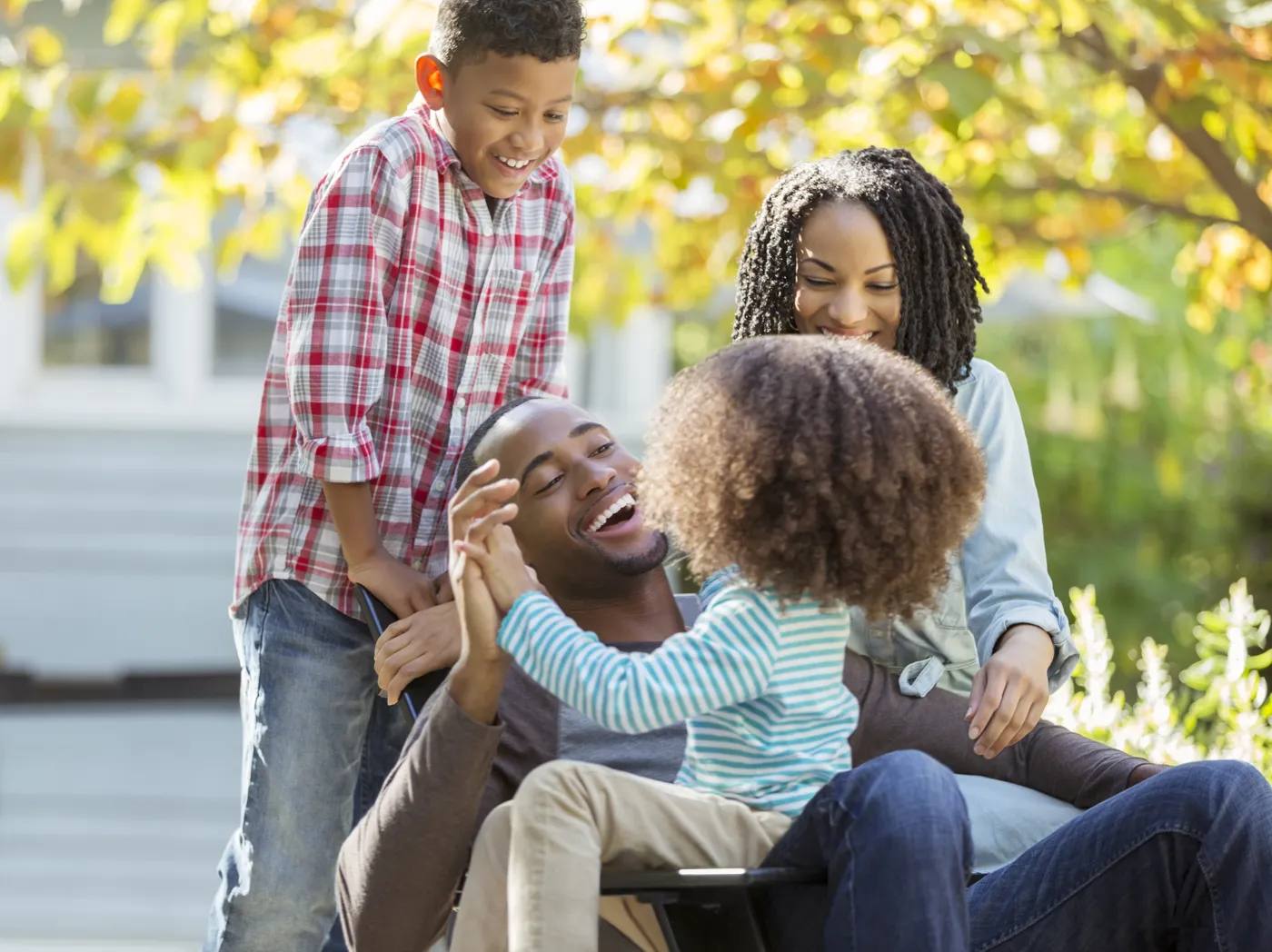 A family laughing together outdoors